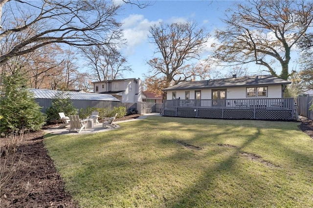 view of yard featuring fence, a patio, and a wooden deck