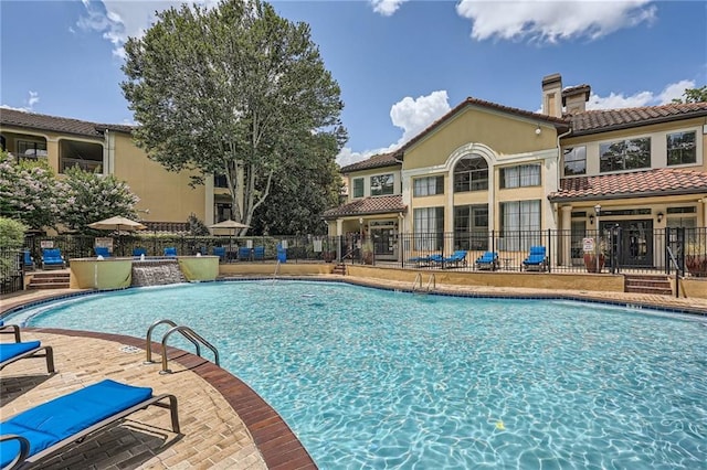 view of swimming pool with a patio and pool water feature