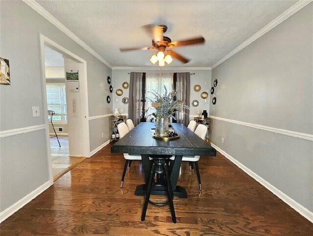 dining area featuring crown molding, dark wood-type flooring, ceiling fan, and a textured ceiling