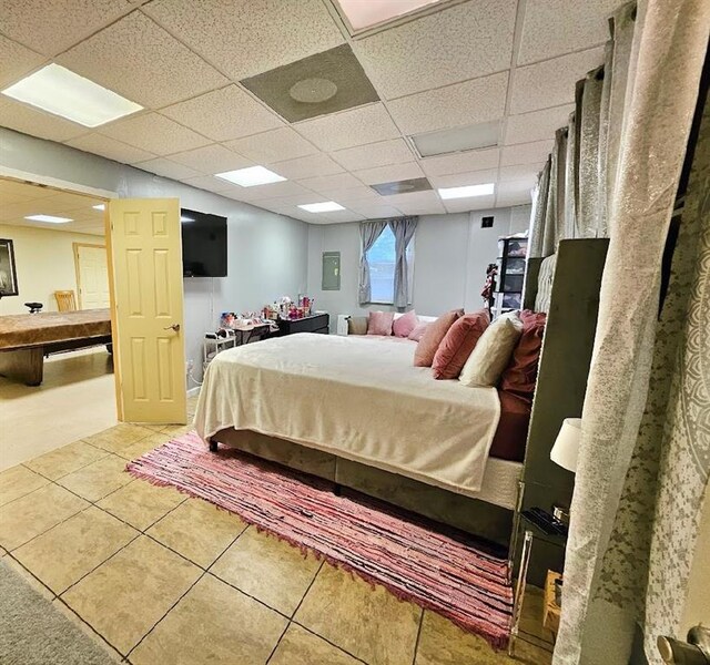 tiled bedroom with a paneled ceiling