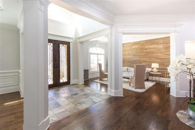 foyer entrance with french doors, ornamental molding, wood finished floors, and arched walkways