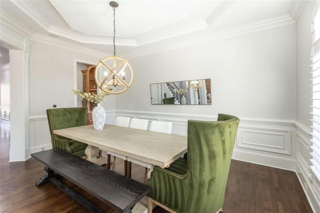 dining room with a chandelier, dark wood-style flooring, a tray ceiling, crown molding, and a wainscoted wall