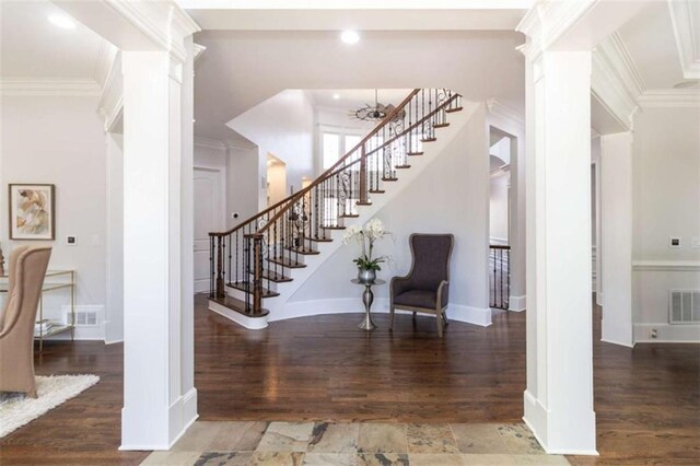 stairs featuring wood finished floors, crown molding, baseboards, decorative columns, and recessed lighting