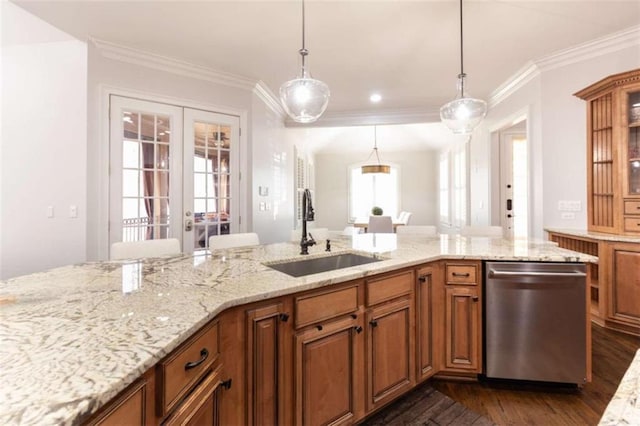 kitchen featuring dishwasher, a sink, crown molding, brown cabinets, and light stone counters