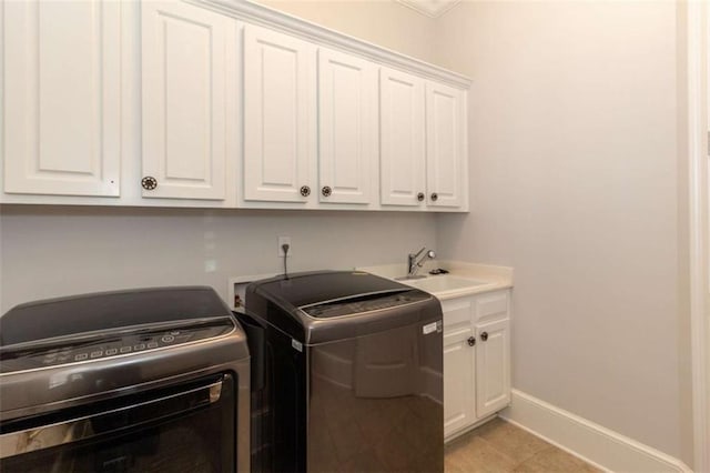 washroom featuring hookup for a washing machine, cabinet space, and baseboards