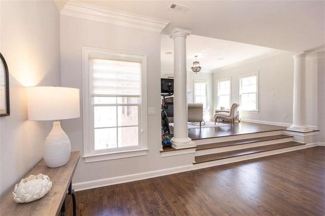 detailed view of ornate columns, ornamental molding, wood finished floors, and baseboards