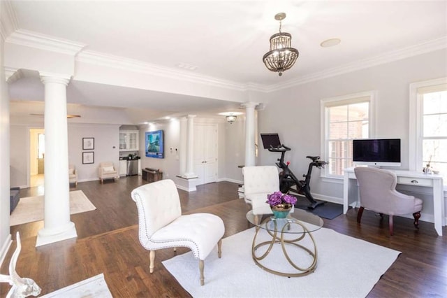 living room featuring decorative columns, wood finished floors, crown molding, and baseboards