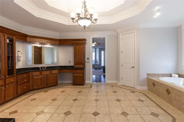 bathroom featuring a chandelier, a tray ceiling, crown molding, tile patterned flooring, and a bath