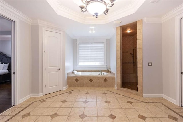 full bathroom with tile patterned flooring, a garden tub, a tile shower, a tray ceiling, and baseboards