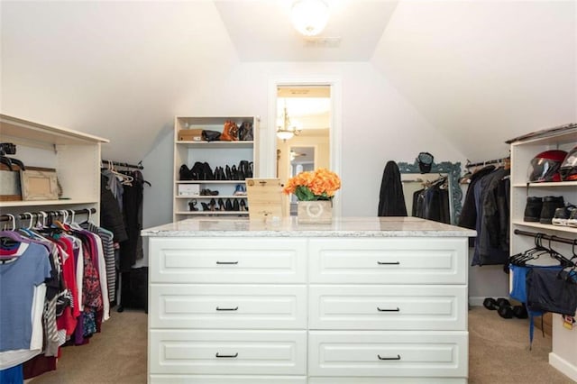 spacious closet featuring vaulted ceiling and carpet flooring