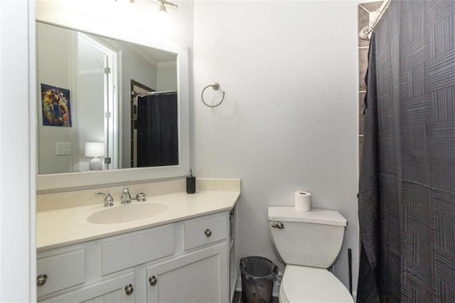 bathroom with vanity, toilet, and curtained shower