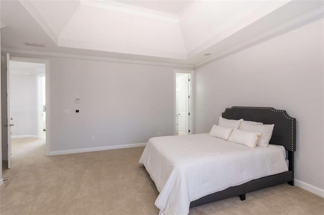 bedroom featuring a raised ceiling, light carpet, crown molding, and baseboards