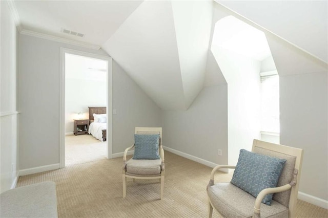 living area featuring carpet floors, vaulted ceiling, baseboards, and crown molding