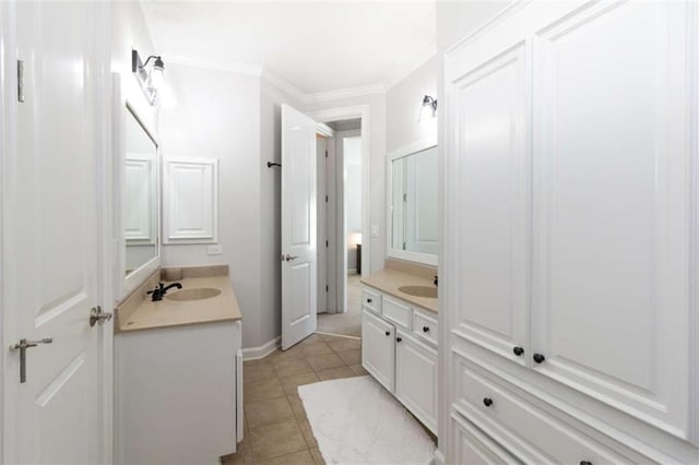 bathroom with two vanities, ornamental molding, tile patterned flooring, and baseboards