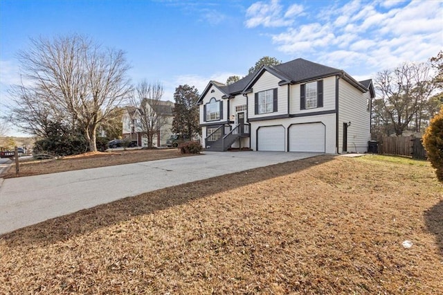 view of home's exterior with a garage and a yard