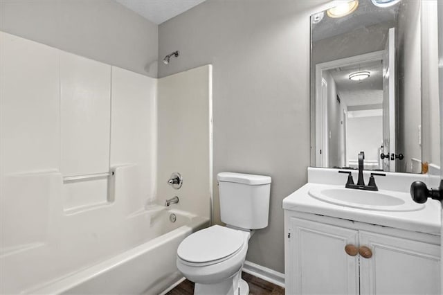 full bathroom featuring vanity, toilet, shower / bath combination, and a textured ceiling