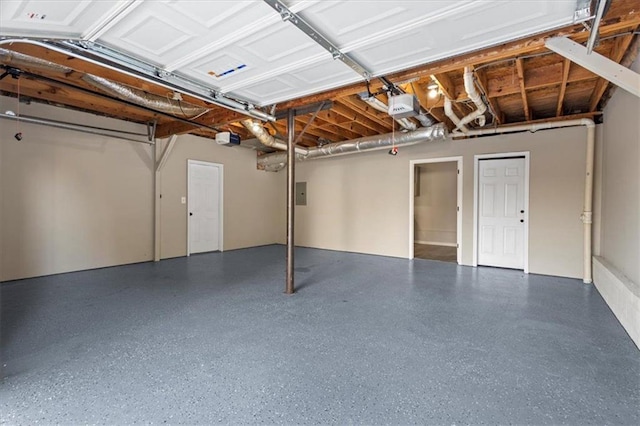 garage featuring a garage door opener and electric panel