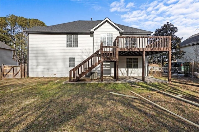 back of property with a lawn and a deck