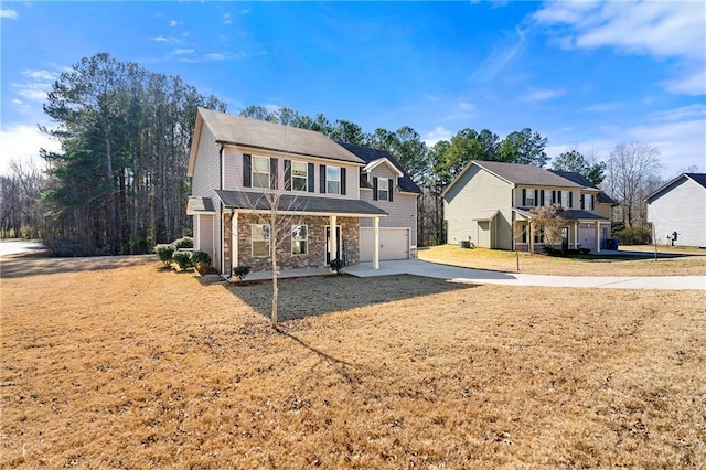 back of property featuring a garage and a yard