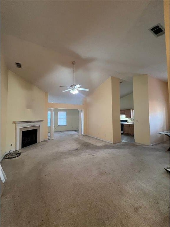 unfurnished living room featuring carpet floors, vaulted ceiling, and ceiling fan