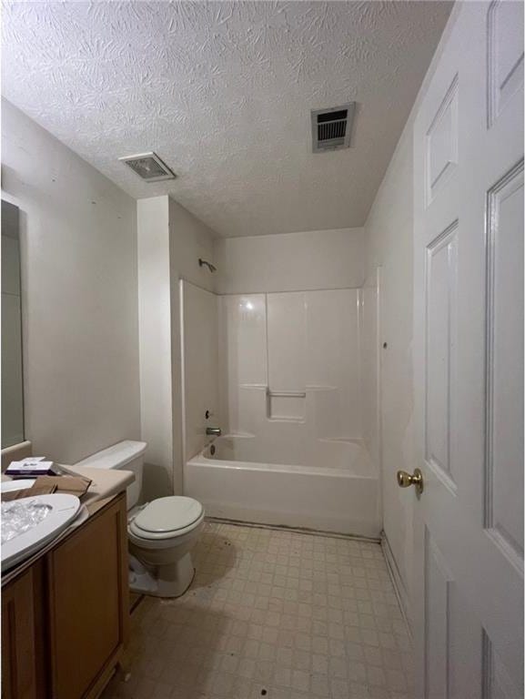 full bathroom with shower / bathing tub combination, vanity, a textured ceiling, and toilet