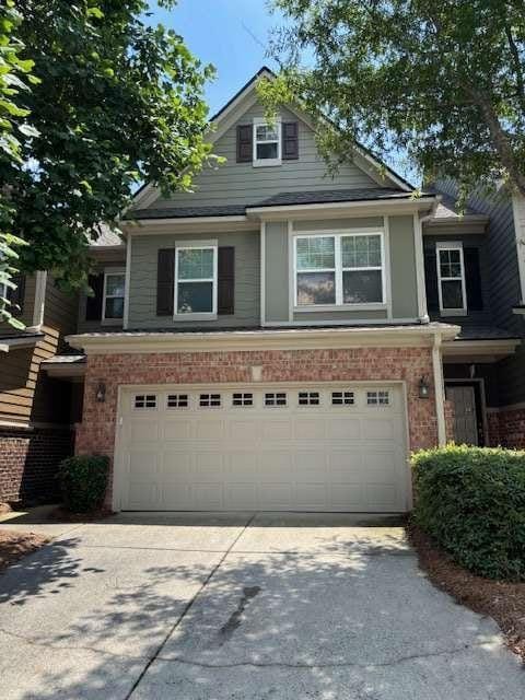 1629 Marsanne Ter, Kennesaw, GA 30152 - view of front of home featuring concrete driveway, an attached garage, and brick siding