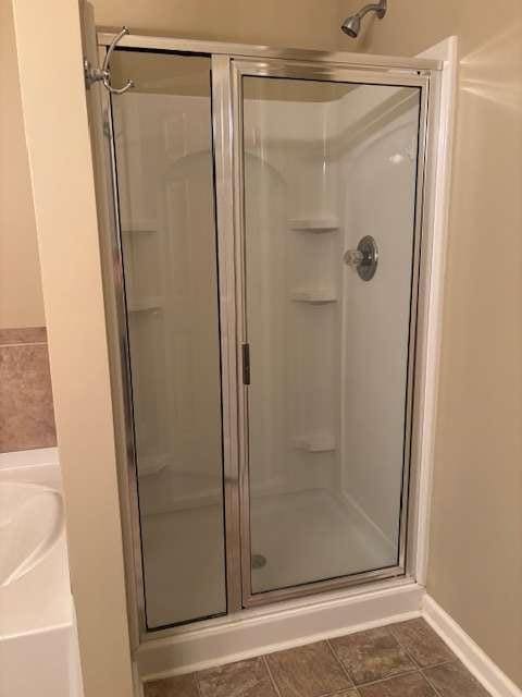 1629 Marsanne Ter, Kennesaw, GA 30152 - full bathroom with a shower stall and baseboards