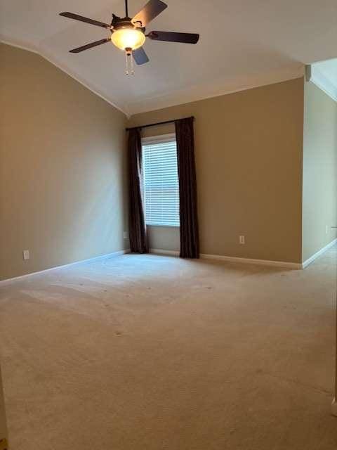 1629 Marsanne Ter, Kennesaw, GA 30152 - spare room featuring lofted ceiling, light carpet, baseboards, and a ceiling fan