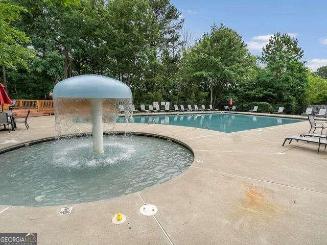 1629 Marsanne Ter, Kennesaw, GA 30152 - community pool with a patio and view of wooded area