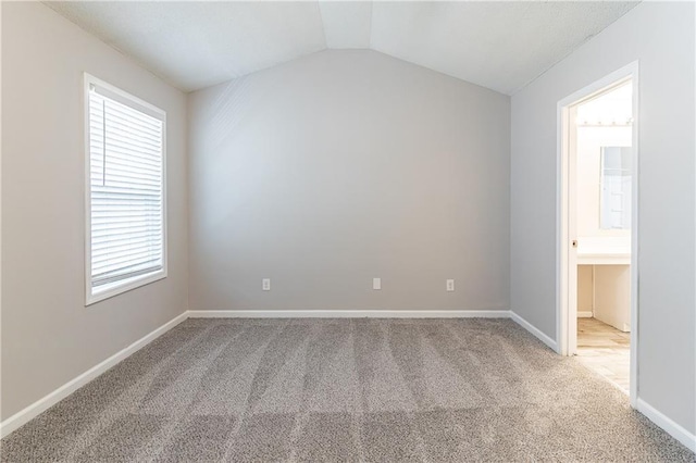 249 Bainbridge Cir, Dallas, GA 30132 - spare room featuring vaulted ceiling, baseboards, a wealth of natural light, and light carpet