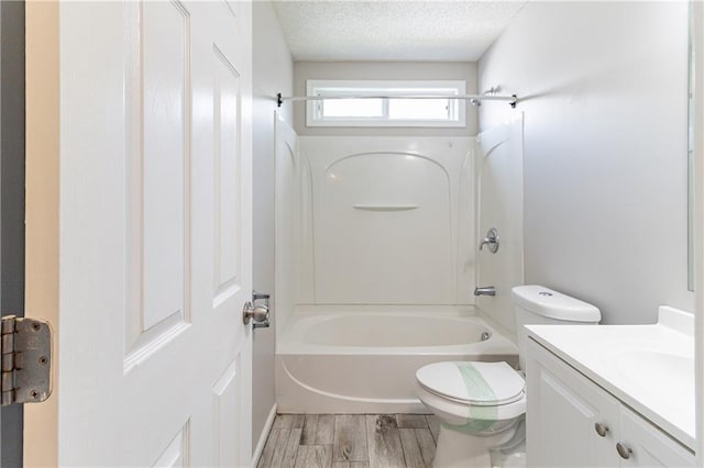 249 Bainbridge Cir, Dallas, GA 30132 - bathroom with toilet, shower / bathing tub combination, wood finished floors, a textured ceiling, and vanity
