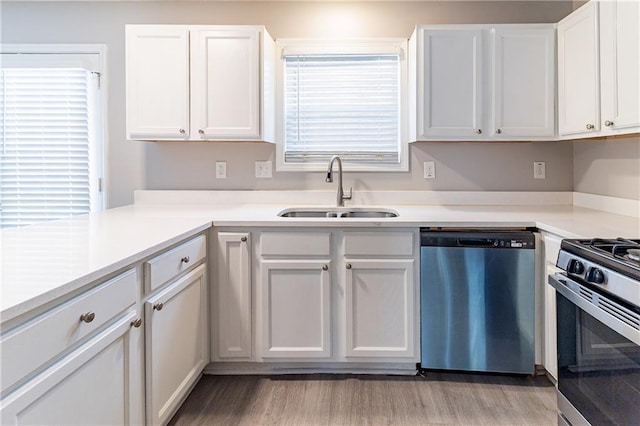 249 Bainbridge Cir, Dallas, GA 30132 - kitchen featuring light wood-type flooring, light countertops, stainless steel appliances, white cabinetry, and a sink