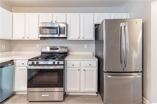 249 Bainbridge Cir, Dallas, GA 30132 - kitchen with white cabinetry, light countertops, and stainless steel appliances