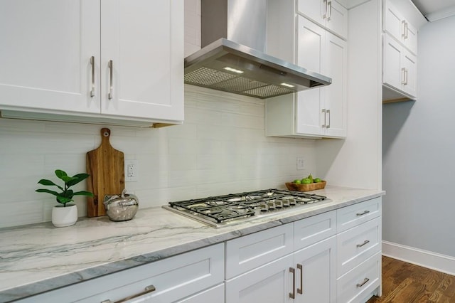 kitchen featuring white cabinetry, dark hardwood / wood-style floors, range hood, and stainless steel gas stovetop