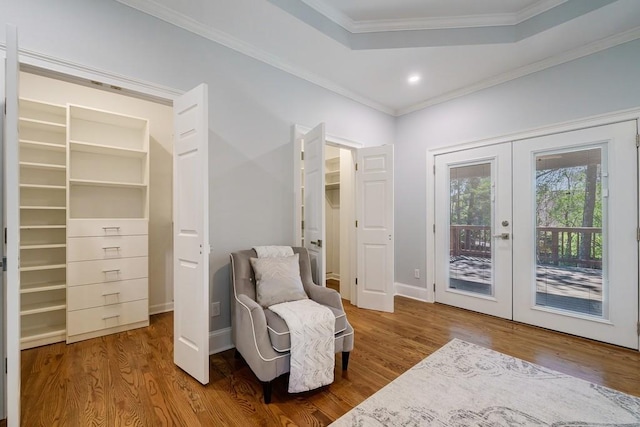 living area featuring french doors, ornamental molding, and hardwood / wood-style floors