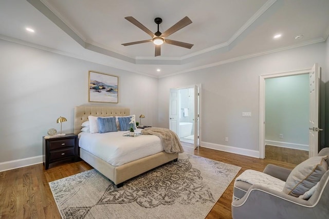 bedroom with a tray ceiling, ceiling fan, crown molding, and wood-type flooring