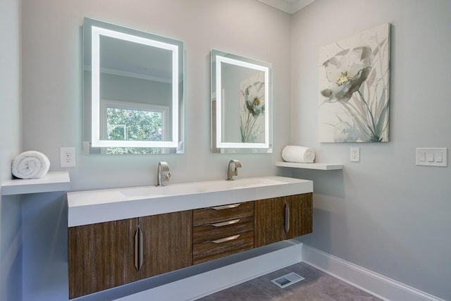 bathroom featuring crown molding and vanity