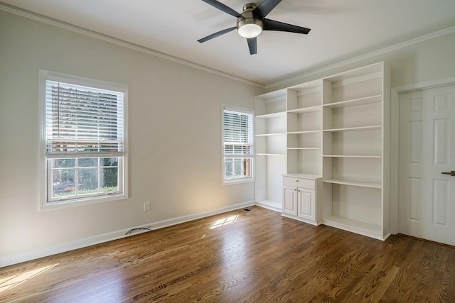 unfurnished room featuring ceiling fan, dark wood-type flooring, and ornamental molding