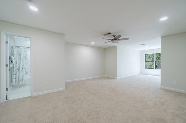 unfurnished room with ceiling fan and light carpet