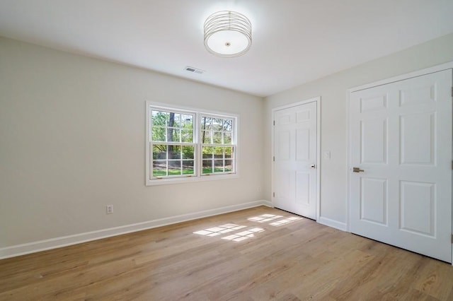 unfurnished bedroom with light hardwood / wood-style floors