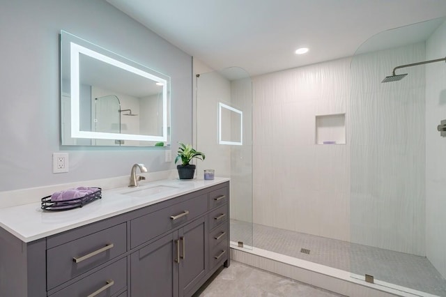 bathroom featuring vanity and a tile shower