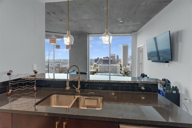 400 W Peachtree St NW Unit 2604, Atlanta, GA 30308 - kitchen featuring a sink, dark stone countertops, and pendant lighting
