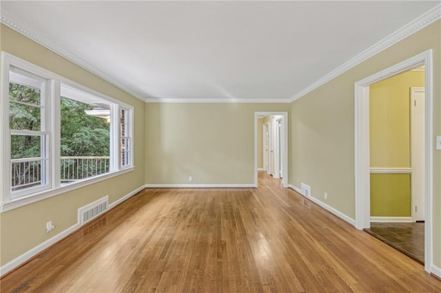 empty room featuring light hardwood / wood-style floors and ornamental molding