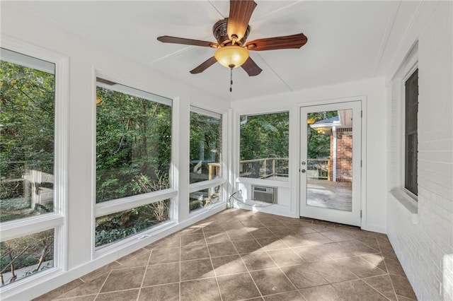 unfurnished sunroom with a wealth of natural light and ceiling fan