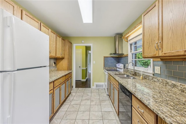 kitchen with white refrigerator, sink, black dishwasher, light stone countertops, and decorative backsplash