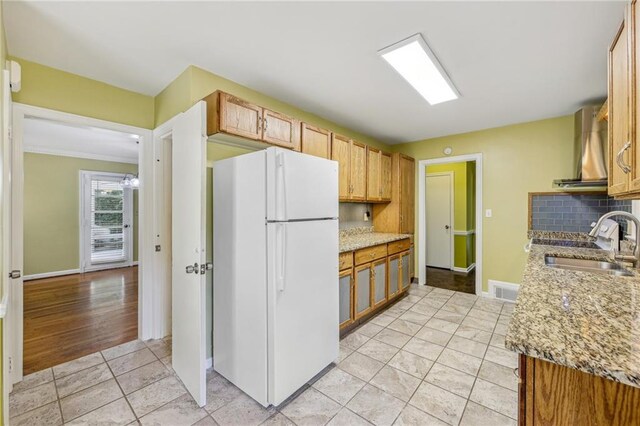 kitchen featuring white refrigerator, tasteful backsplash, sink, wall chimney range hood, and ornamental molding