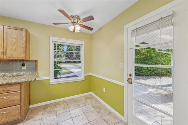 doorway to outside featuring ceiling fan, plenty of natural light, and light tile patterned floors