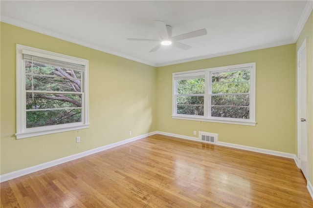 unfurnished room with crown molding, light hardwood / wood-style floors, and ceiling fan