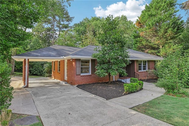 ranch-style home featuring a carport