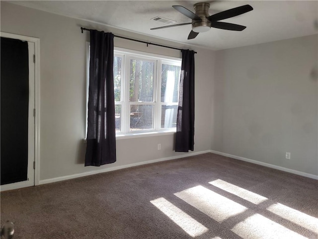 empty room with ceiling fan and carpet floors